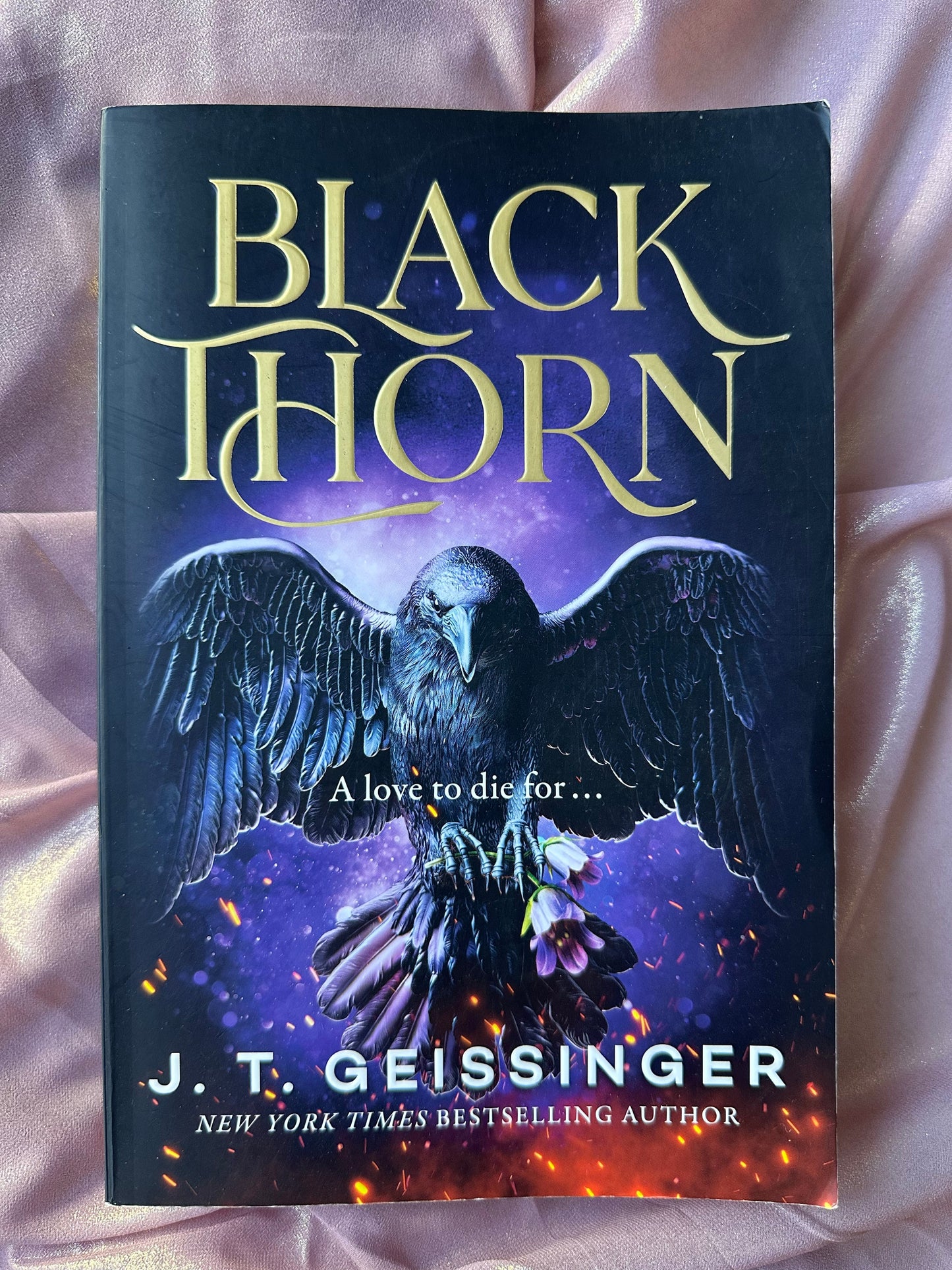 Book titled 'Black Thorn' by J.T. Geissinger with a bird illustration on a purple background.